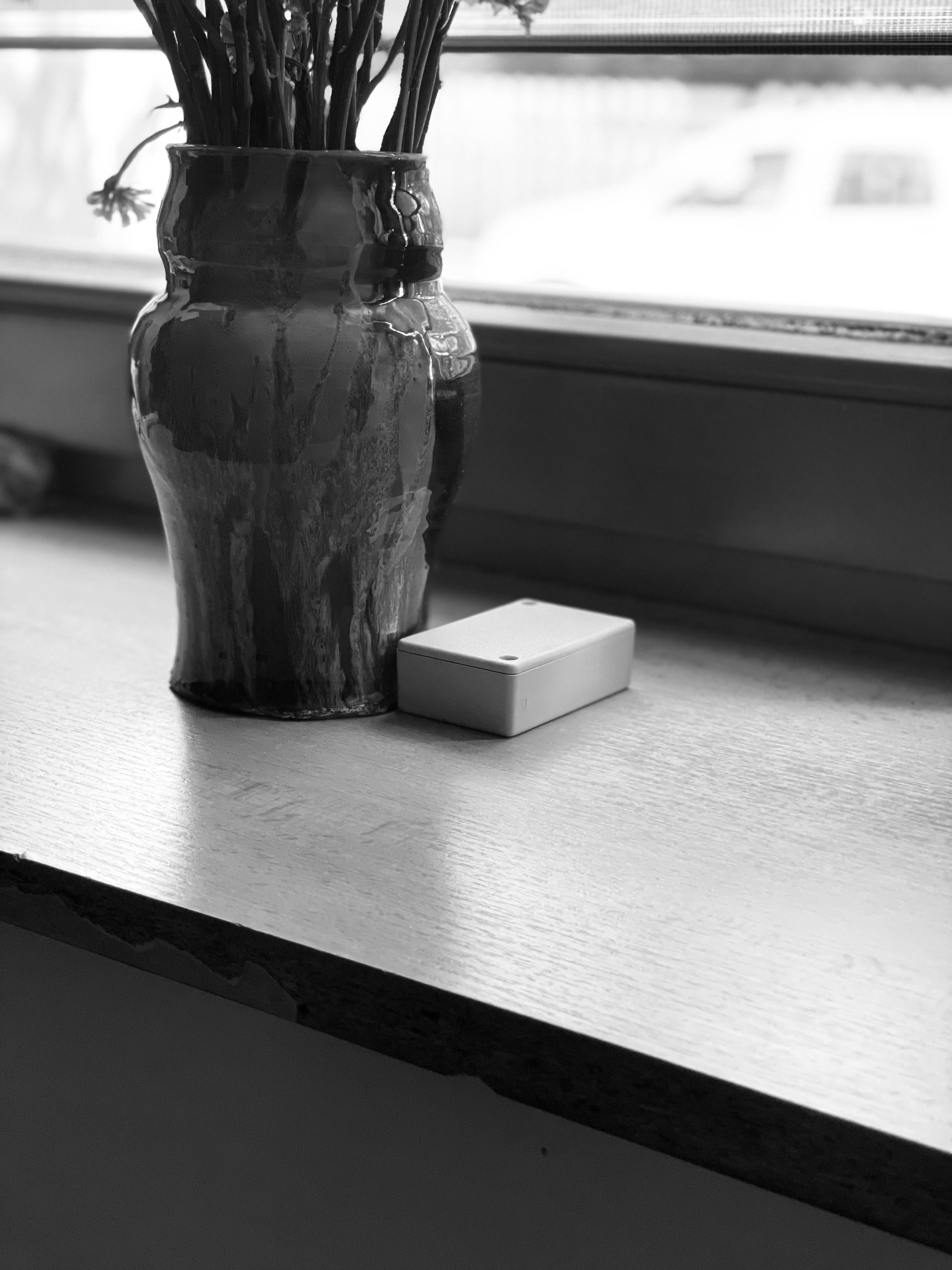 The sensor box plugged in, in a room.